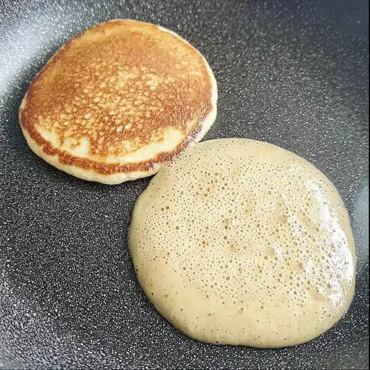 High-Protein Cottage Cheese Banana Pancakes Recipe 8 Cottage Cheese Banana Pancakes cooking on skillet, golden and fluffy